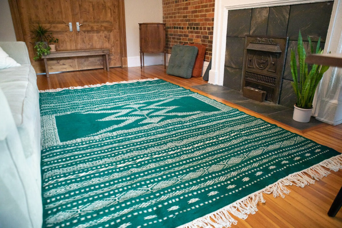 Living room with green area rug.