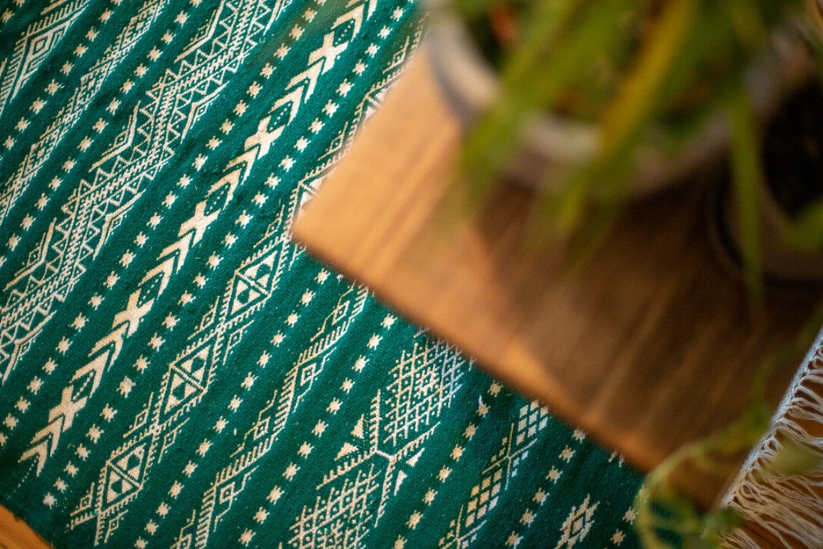 Green Berber rug with white geometric pattern