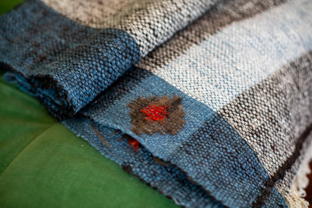Close up of red motif on blue dyed blanket