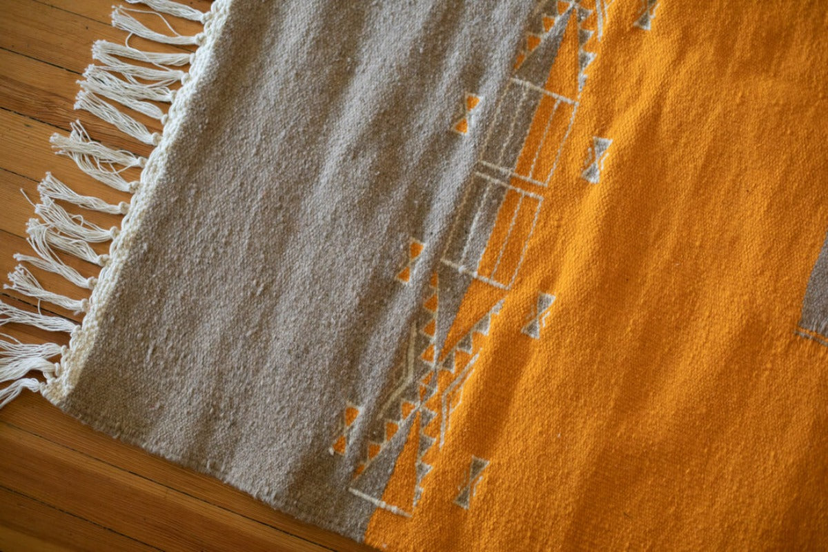 Two-toned area rug of gray and mustard