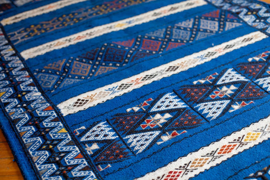 Blue berber rug with geometric patterns.