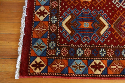 Red area rug with motifs