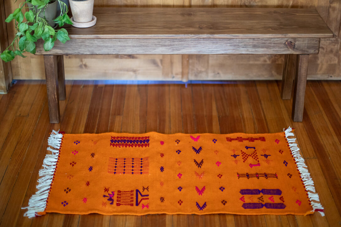 Orange rug with motifs