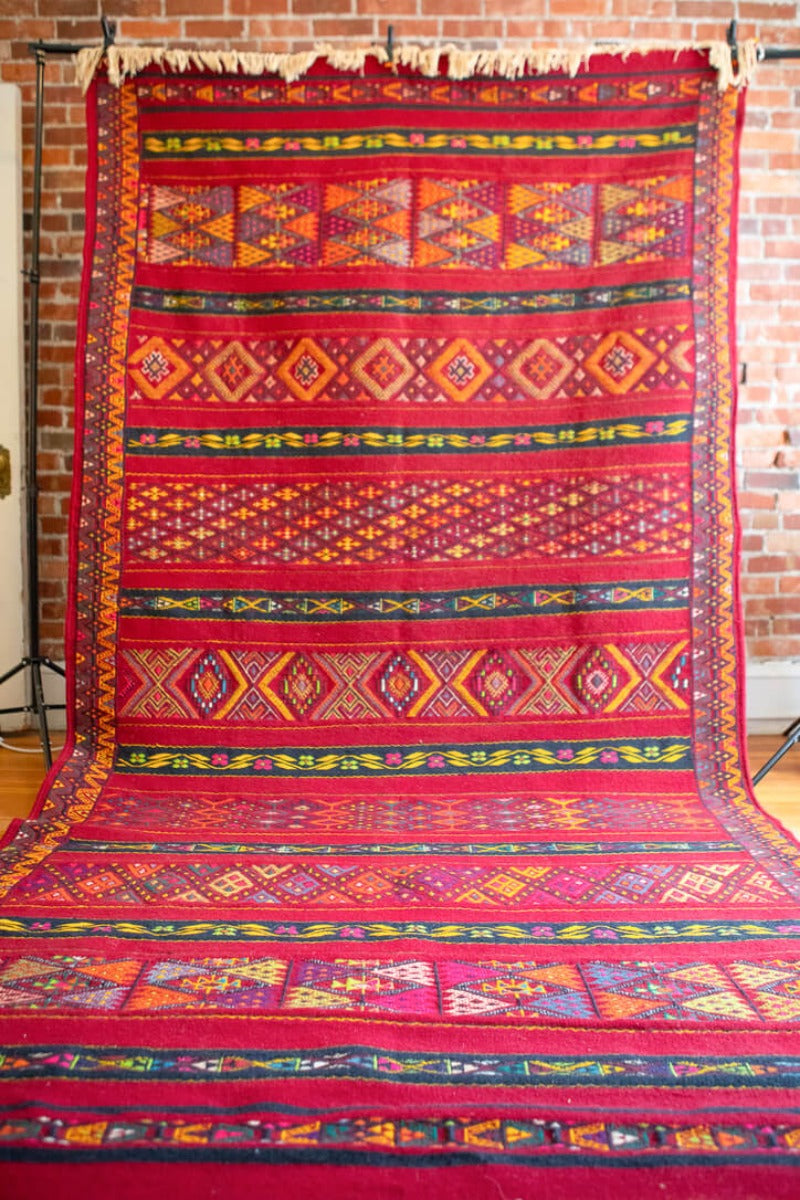 Full length red geometric rug
