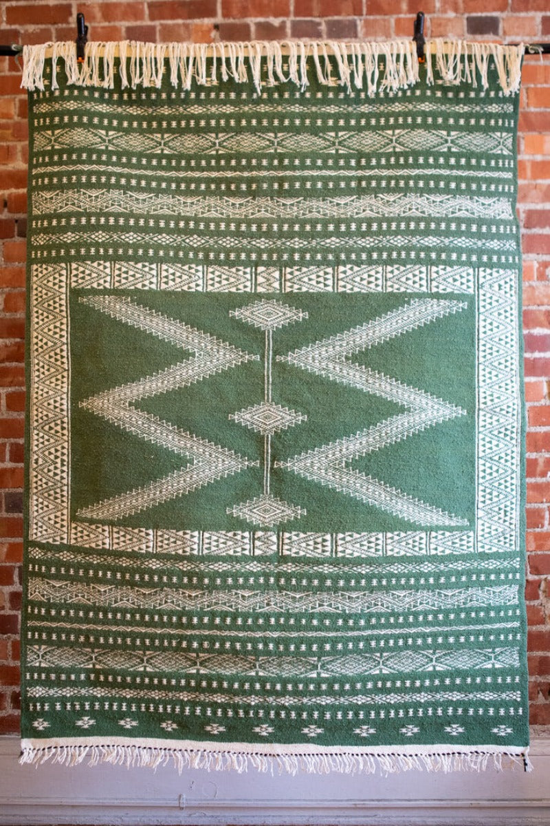 Wool rug with green and white design