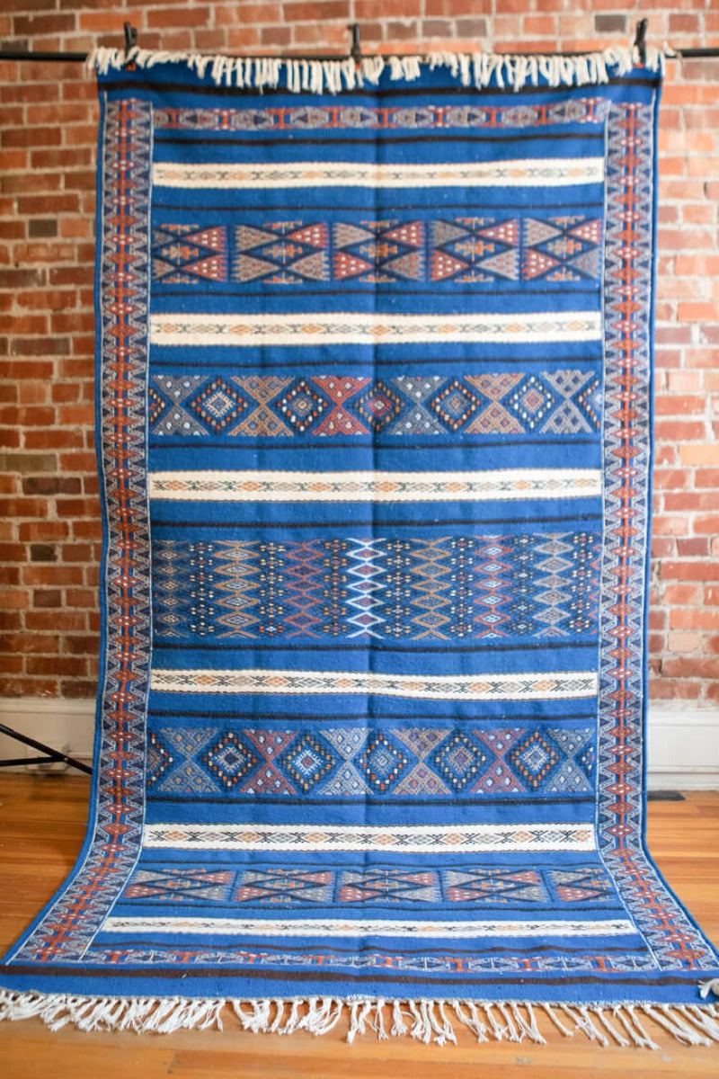 Blue berber rug with geometric patterns.