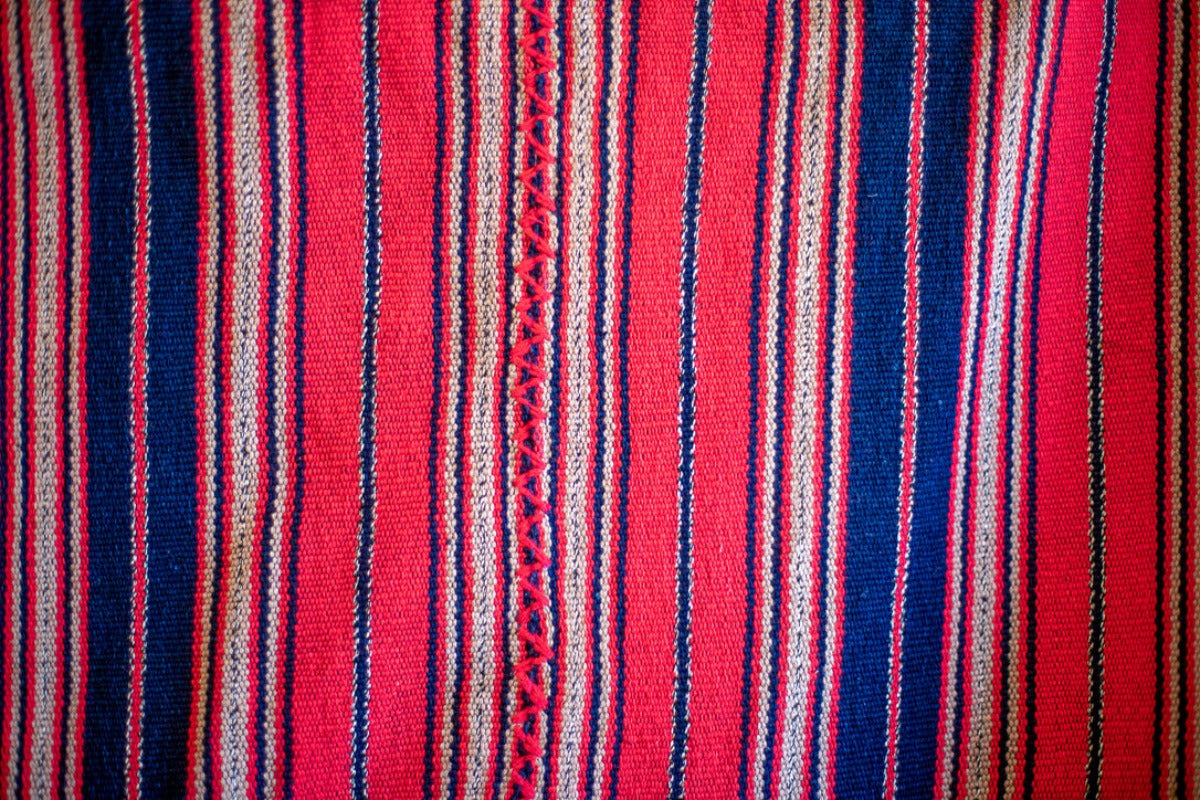 Blue and red striped bedspread with hand stitching