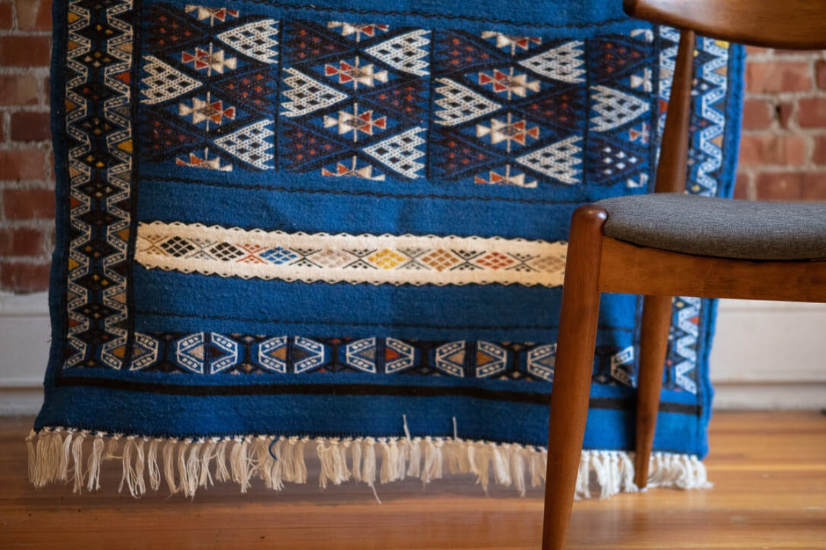 Blue rug with chair in front