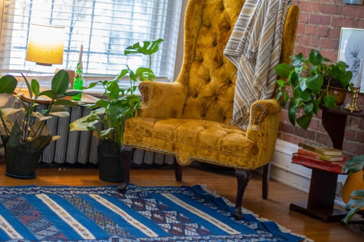 Living room corner with blue rug