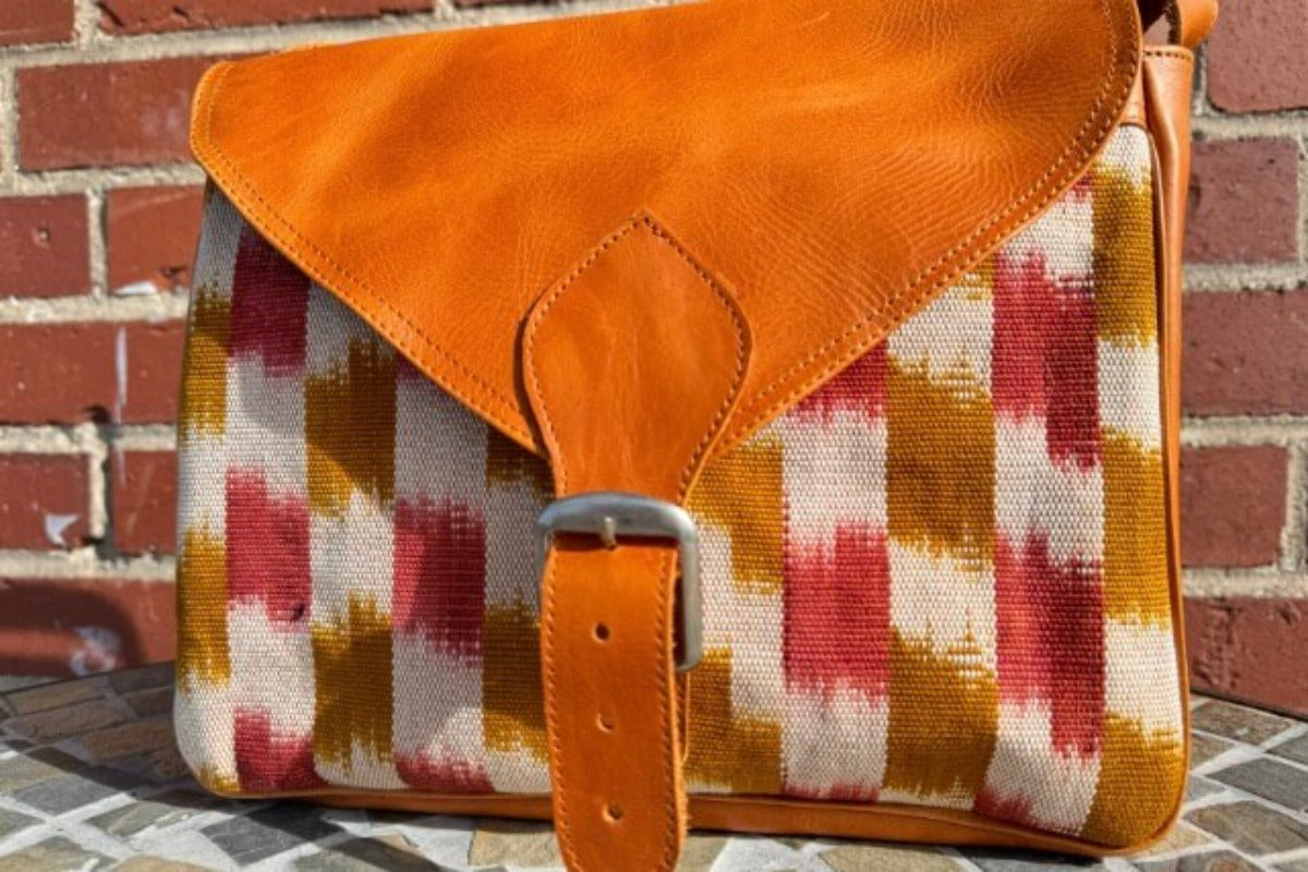 Bag with leather front strap and woven textile design