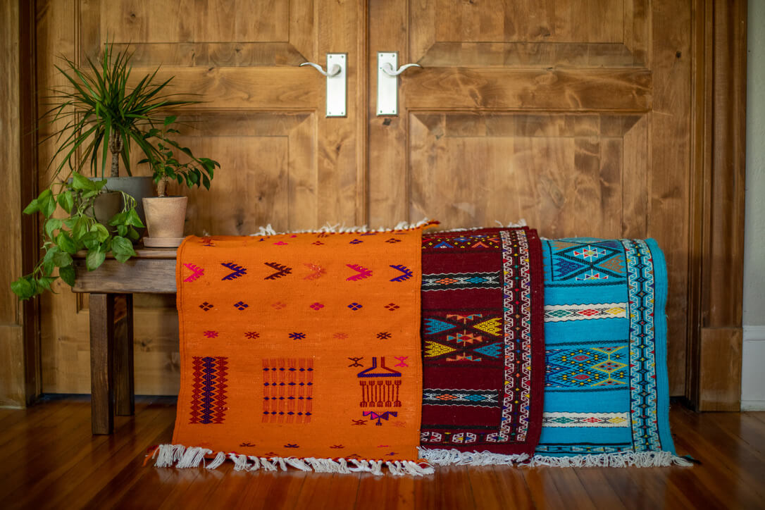 Three small Berber Rugs on a bench