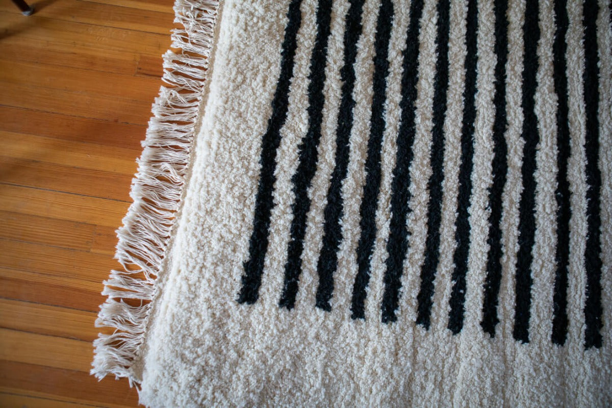 White rug with dark stripes